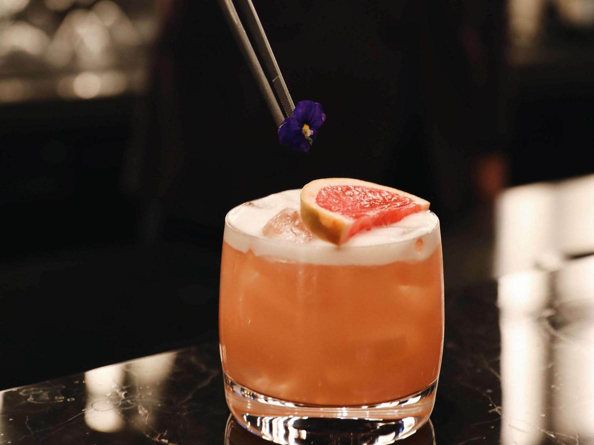 Sofitel Istanbul Taksim Hotell Eksteriør bilde A cocktail being garnished with edible flowers